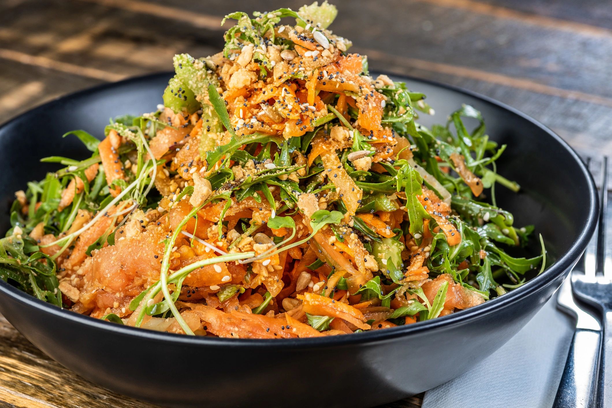 Fresh Thai-style salad served on a wooden table