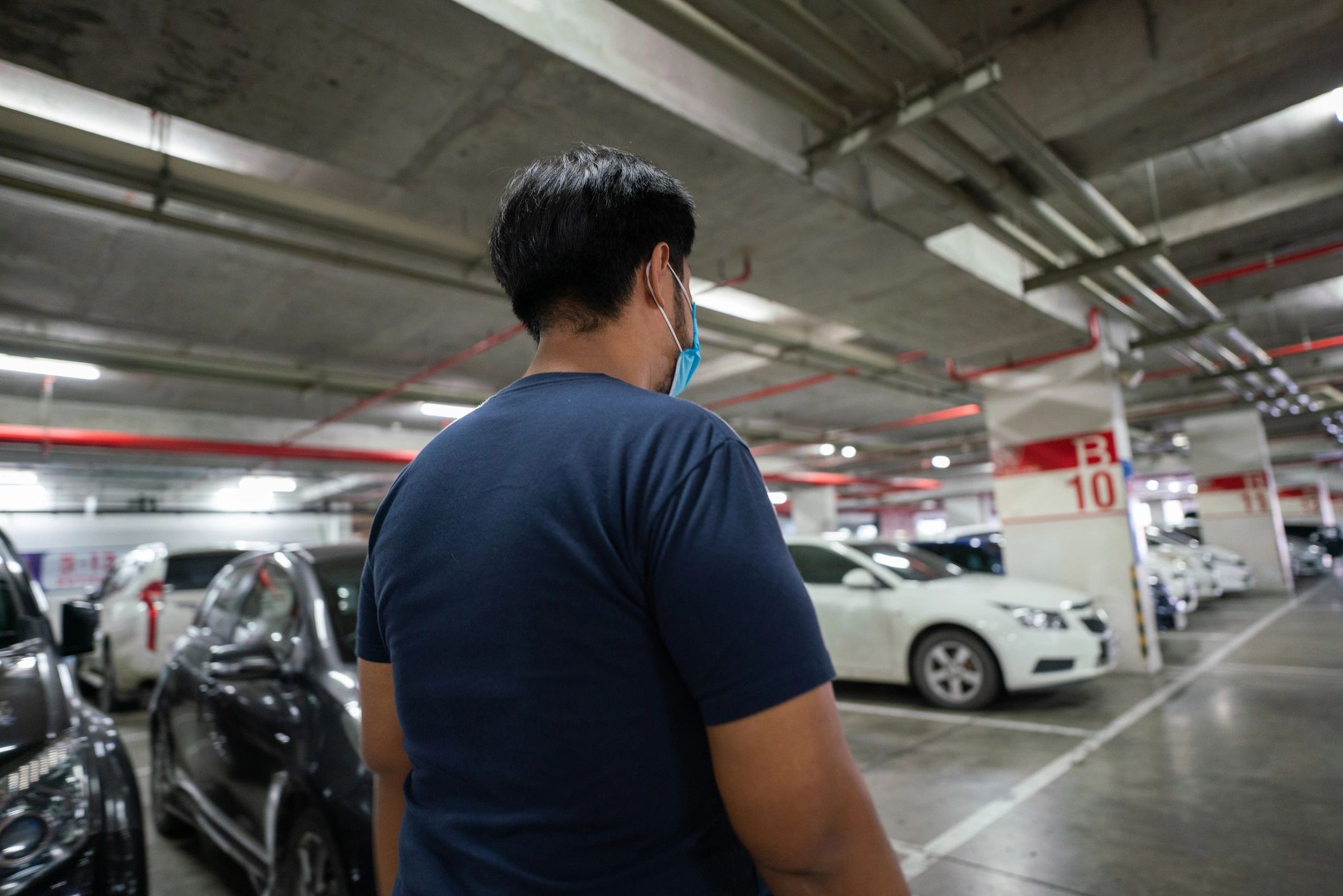 Driver walking through a parking area toward a vehicle