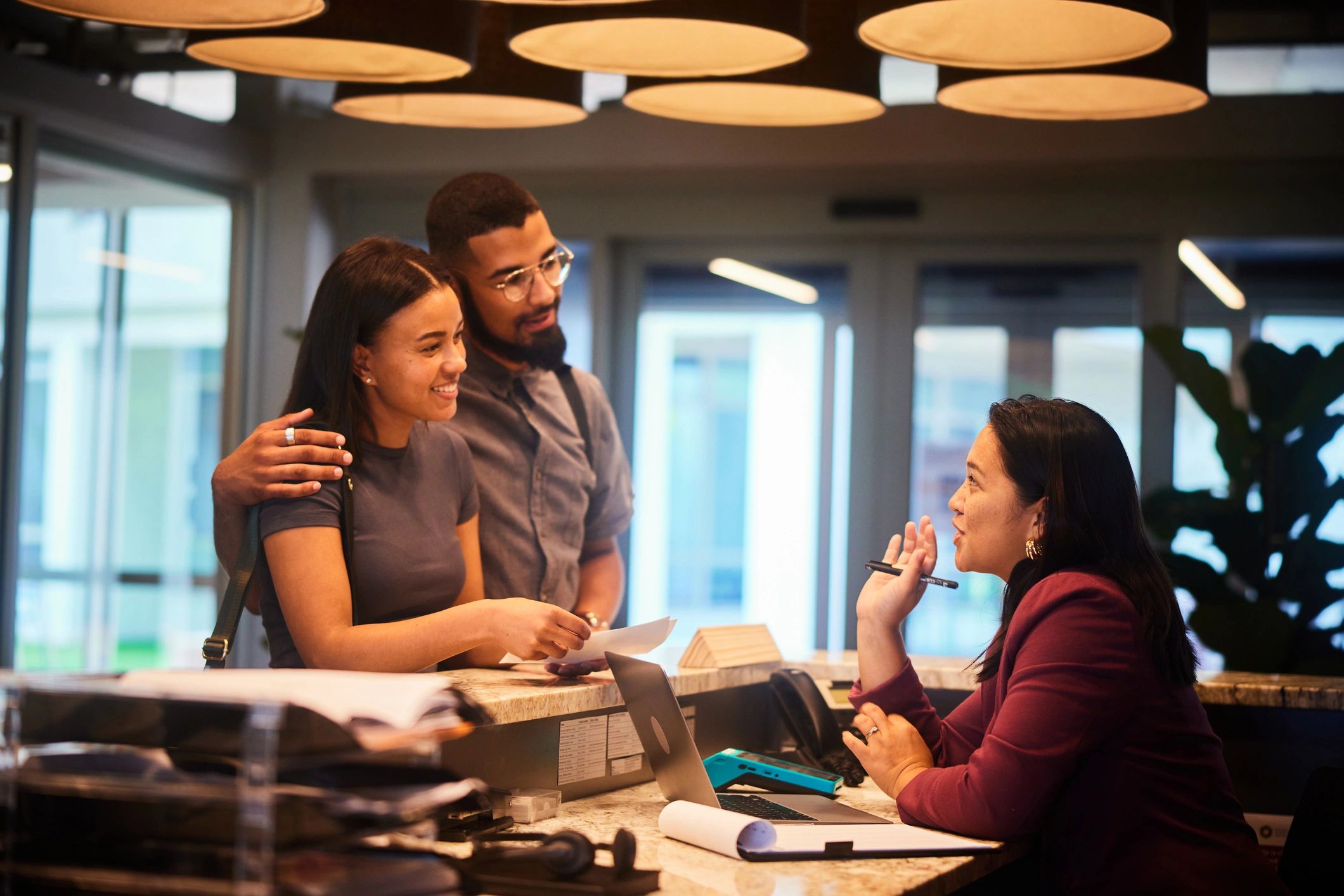 Couple speaking with a hotel receptionist during check-in