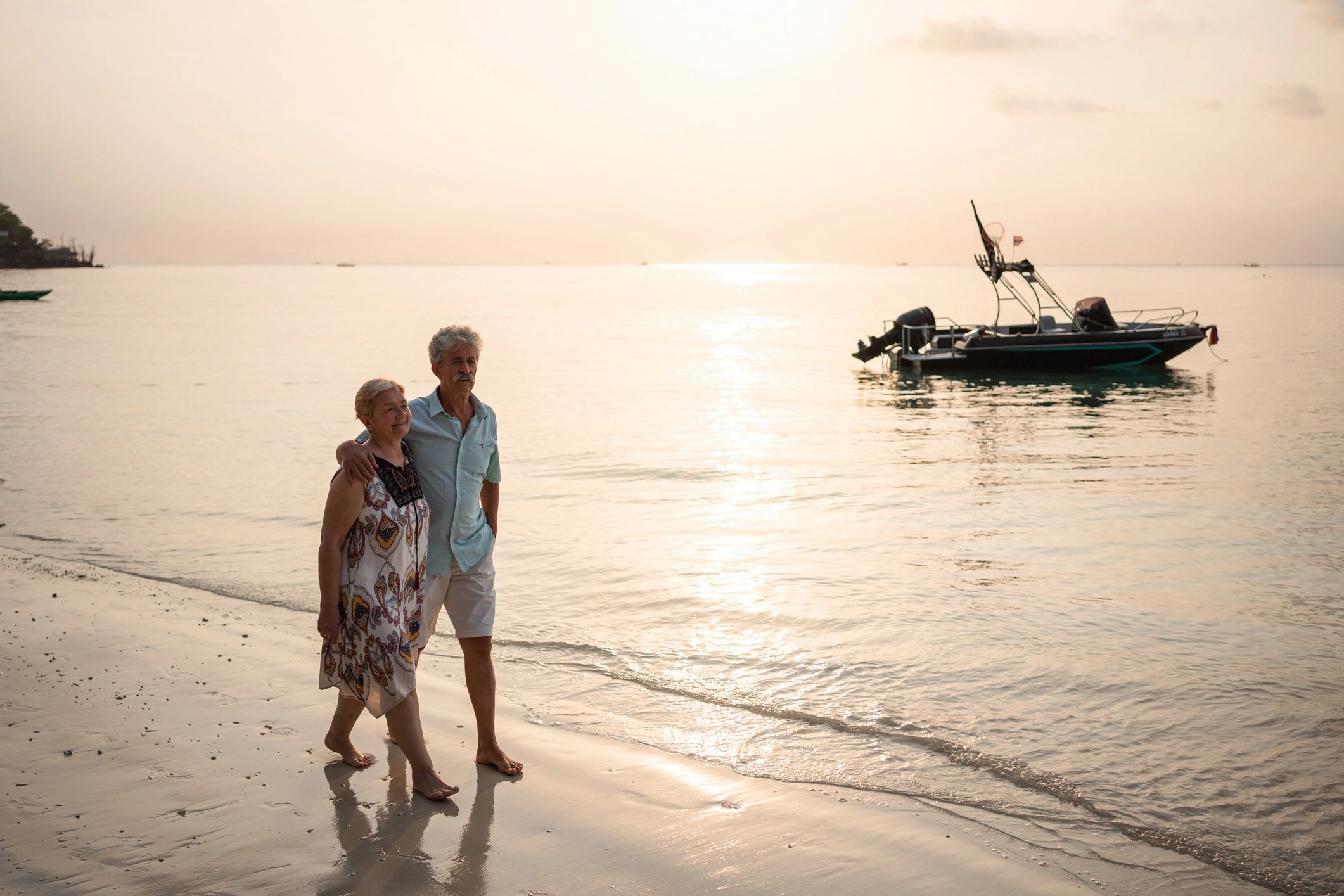 Senior couple walking along a sandy beach