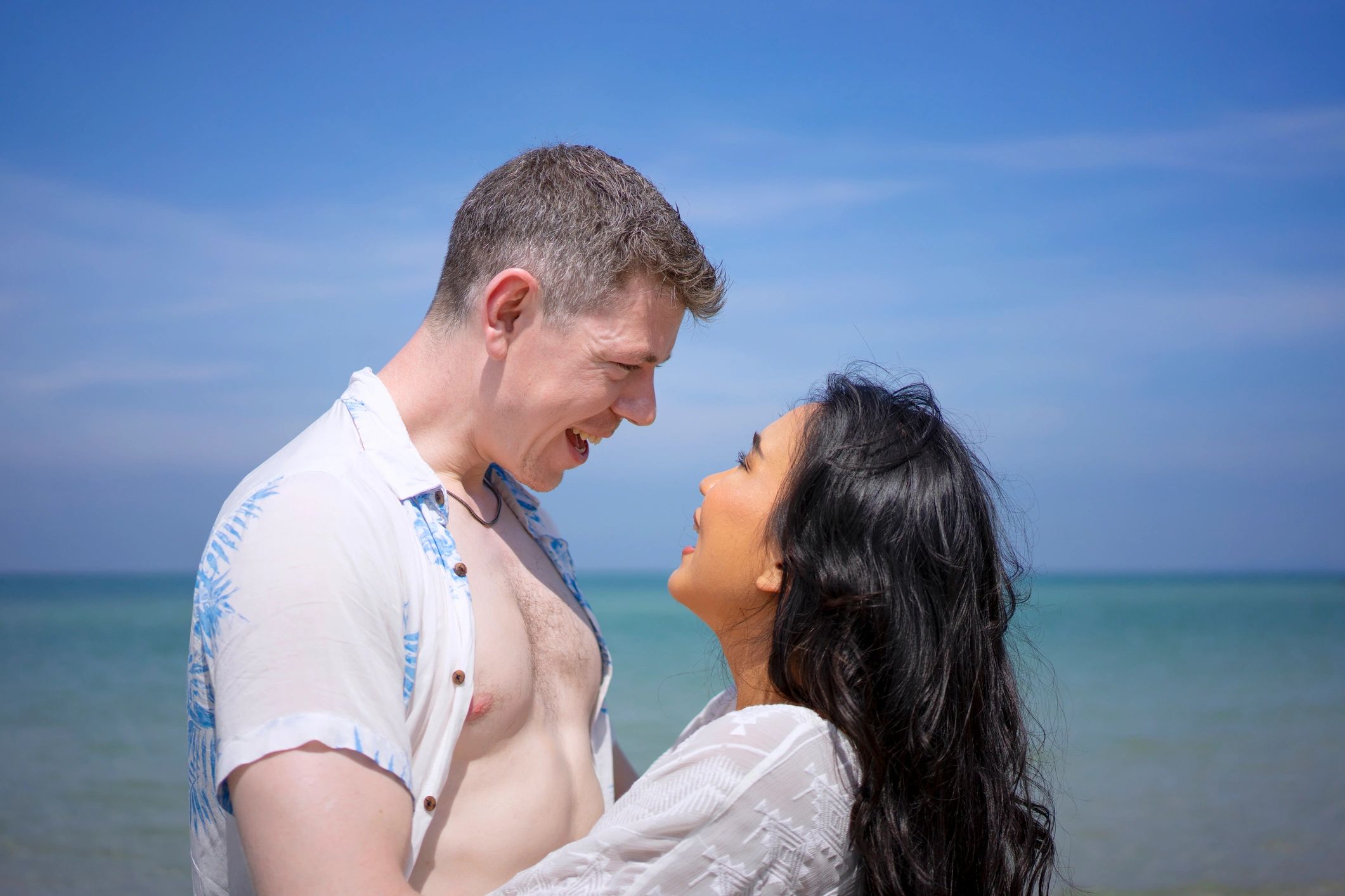 Couple walking on a beach in Thailand