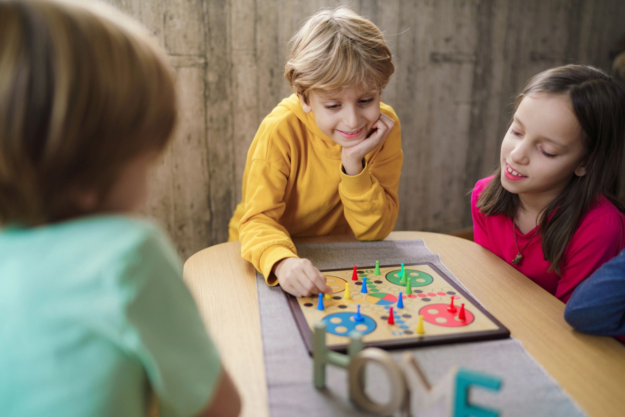 Children playing a board game at home