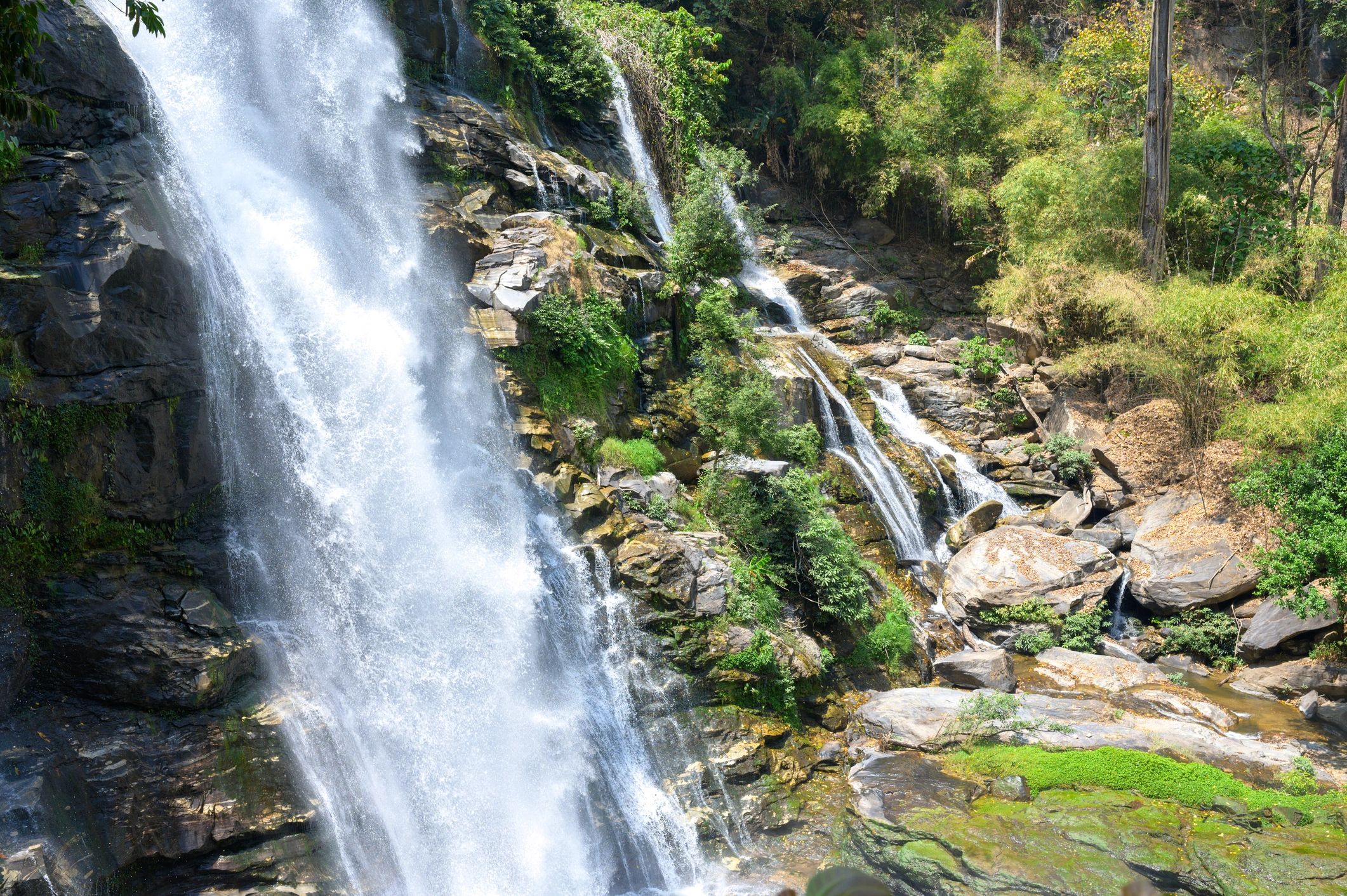 Mountain waterfall surrounded by greenery in Thailand