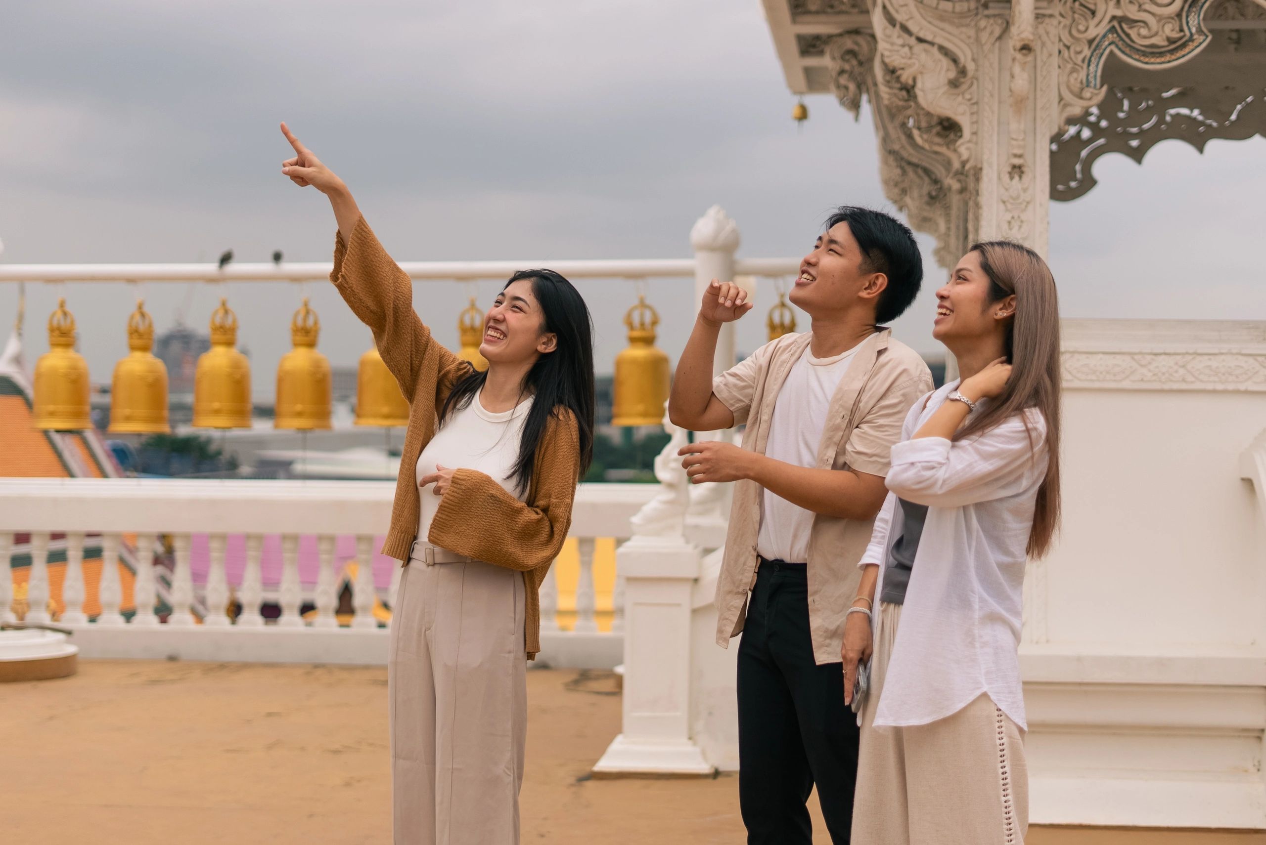 Group of travelers exploring a Thai temple rooftop