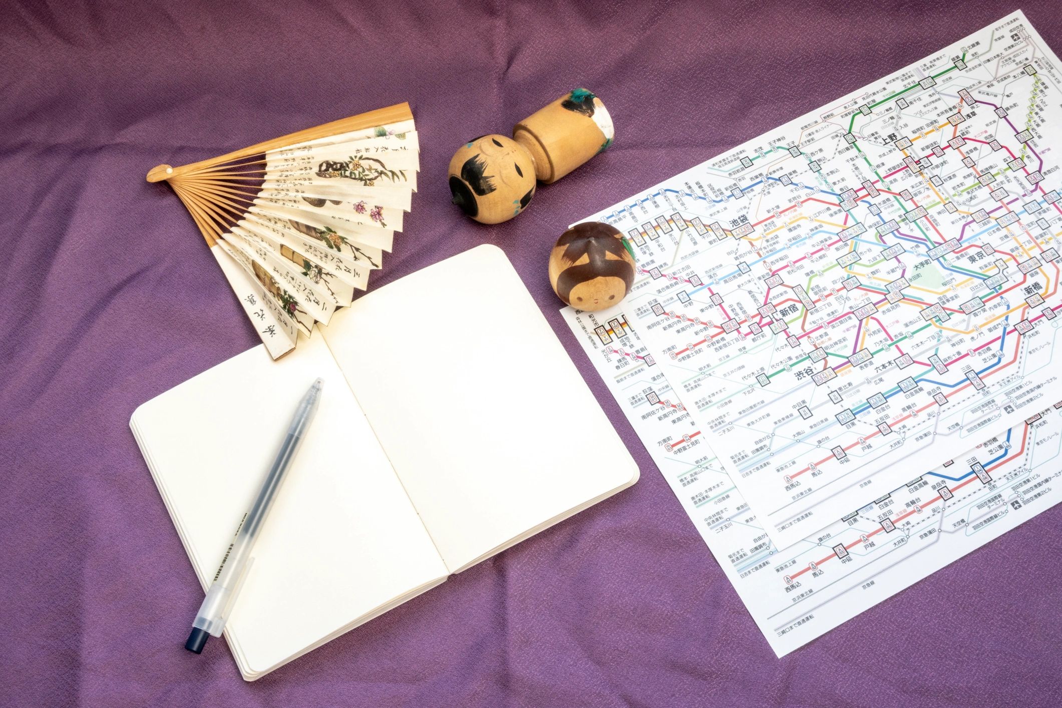 Travel planning flat lay with notebook and map