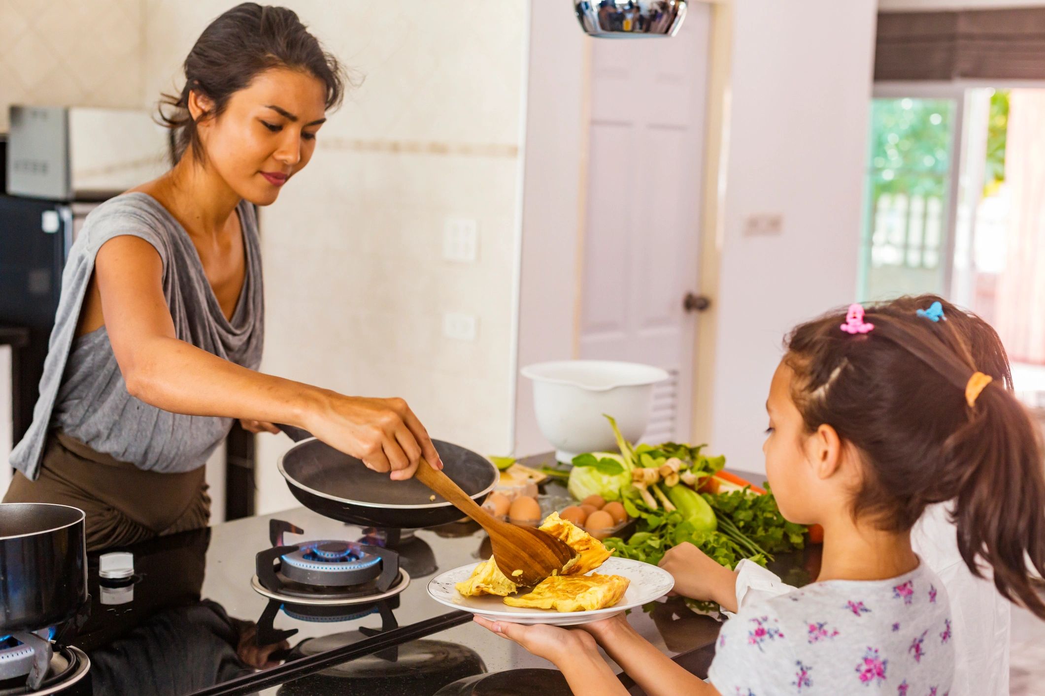Smiling woman cooking in a home kitchen